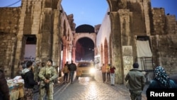 People walk in Damascus on December 9 following the ouster of Syrian President Bashar al-Assad.