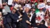 Republican presidential candidate and former U.S. President Donald Trump is assisted by U.S. Secret Service personnel after shots were fired during a campaign rally in Butler, Pennsylvania, on July 13.