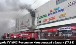 Smoke billows from the shopping center on March 25