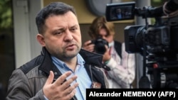 Sergei Boiko, the head of Aleksei Navalny's Novosibirsk headquarters and a City Council candidate, talks to the media in front of a polling station in Novosibirsk on September 13, 2020. 