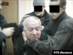 A still image taken from an undated video shows Skripal being detained by secret service officers in an unknown location.