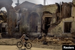 A person cycles past a train station that was damaged by repeated shelling in Kostyantynivka in eastern Ukraine. (file photo)