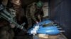 Ukrainian soldiers prepares mortar shells before firing them toward positions of Russian troops on the outskirts of Bakhmut on December 30.