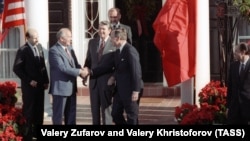 Soviet leader Mikhail Gorbachev (second from left) shakes hands with U.S. Vice President George Bush as President Ronald Reagan stands behind them before talks in New York in December 1988.