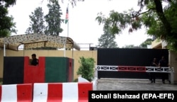 Security guards stand outside the Afghan Embassy in Islamabad. (file photo)