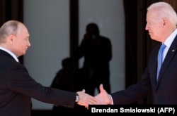 Vladimir Putin (left) shakes hands with Joe Biden prior to the summit in Geneva on June 16.