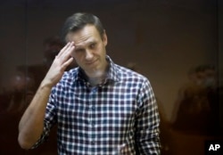 Navalny stands in a cage in the Babuskinsky District Court in Moscow on February 20, 2021.