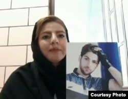 Farzaneh Ansarifar with a picture of her dead brother, Farzad.