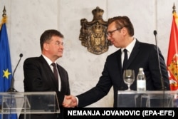 The EU's special representative for the Pristina-Belgrade dialogue, Miroslav Lajcak (left) and Serbian President Aleksandar Vucic shake hands after their meeting in Belgrade on October 15.