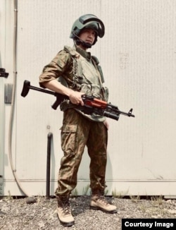 Hayato Sato dressed in the uniform of an FSB special forces fighter from the late 1990s, complete with a replica Kalashnikov fitted with a grenade launcher.