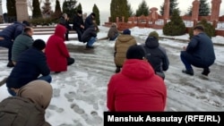 Activists and relatives at the grave of Altynbek Sarsenbaiuly outside Almaty on February 11. 