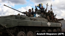 Ukrainian servicemen on the road near the city of Lyman, which was liberated from Russian forces earlier this month. 