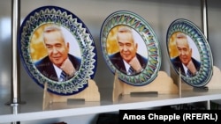 Souvenir plates featuring a portrait of former President Islam Karimov on sale in Samarkand (file photo)