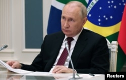 Russian President Putin attends the 2023 BRICS Summit in South Africa via video link from Moscow.