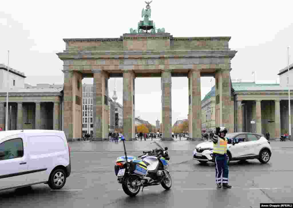 East Berlin border guards stand atop the Berlin Wall in front of the Brandenburg Gate on November 11, 1989. Two days earlier, on November 9, the wall was breached by thousands of Germans after an East German official indicated that travel restrictions between East and West Germany were to be ended &quot;without delay.&quot;&nbsp;&nbsp;