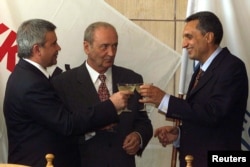 Then-Bulgarian Prime Minister Ivan Kostov (right) has a glass of champagne with the LUKoil President Vagit Alekperov (left) and then-Russian Ambassador to Bulgaria Leonid Kerestedzhiants after the signing of the Burgas privatization agreement in October 1999.