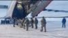 Russian servicemen board a military aircraft on their way to Kazakhstan, at an airfield outside Moscow on January 6. 