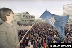 A protester waves the flag of Mongolia's Democratic Party in Ulan Bator in July 1990.