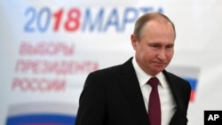 Russian President Vladimir Putin arrives to vote at a polling station in Moscow on March 18.