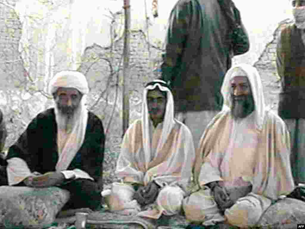 Osama bin Laden (right) sits with his son Mohammed (center) and one of his top aides, Mohammed Atef, during Mohammed's wedding to Atef's daughter in Kandahar in January 2001.