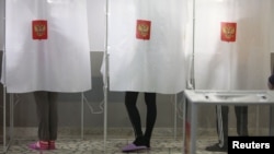 Russians in the voting booths at Stavropol State University's student hostel during the last presidential election in Russia, in March 2012.