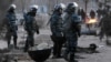 Riot police patrol the Kazakh town of Zhanaozen shortly after violence claimed the lives of at least 16 striking oil workers.