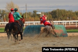 A Kyrgyz player hoists a synthetic goat carcass into the the goal, a tai-kazan, during a dominant 12-0 win over Uzbekistan in the early rounds of the kok-boru competition on September 9.