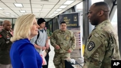 Secretary of the U.S. Army Christine Wormuth (left) speaks with a solider at an army recruiting display. (file photo)