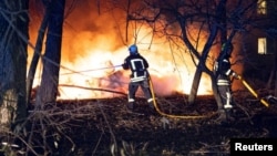 Firefighters work at the site of a residential area hit by a Russian missile strike in Sumy on November 17.