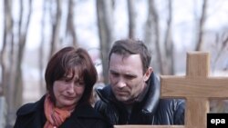 The parents of Maksim Mareyev, who was killed by one of the bombings in Moscow's subway on March 29, mourn at his funeral on March 31.