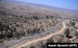 Pakistani soldiers patrol the newly fenced border next to Afghan's Paktika Province border in Pakistan's South Waziristan.