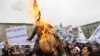 Afghan protesters burn an effigy of U.S. President Barack Obama. With just three years before the West hands off full control of the country's security, questions remain over Afghanistan's political maturity.