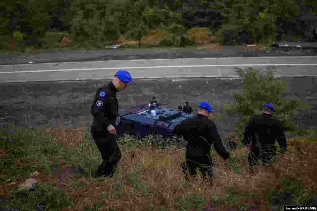 EU police officers patrol near the border at Jarinje on September 28. European Commission spokeswoman Diana Spinant on September 27 urged both sides to &quot;sit down together and to put an end to the verbal escalation in the region.&quot;