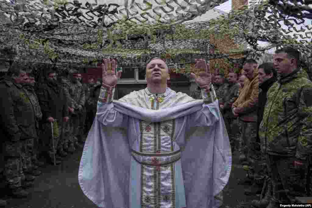 Military chaplain Yuriy of the 24th Mechanized Brigade holds a church service for an infantry unit during Christmas near the frontline town of Chasiv Yar, Donetsk region, Ukraine.