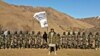 The Taliban assigned Tajik militant Muhammad Sharifov (center), who goes by the alias Mahdi Arsalon, to raise the Taliban flag at a strategic checkpoint near Afghanistan's border with Tajikistan last month.