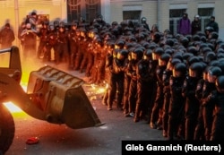 Protesters brought a tractor to try to break through police lines near the presidential administration building in Kyiv on December 1.