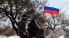 Members of a local "self-defense" unit man a checkpoint on the highway between Simferopol and Sevastopol in Crimea in March.