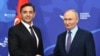 Serbian Deputy Prime Minister Aleksandar Vulin (left), whose party sponsored the bill, meets with Russian President Vladimir Putin on the sidelines of the Eastern Economic Forum in Vladivostok in September.