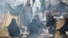 Migrants gather around a fire in a camp in the Hrodno region of Belarus on November 18.