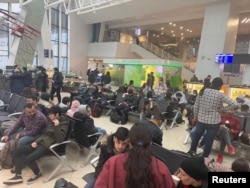 Iraqi migrants wait for an evacuation flight at the Minsk airport on November 18.