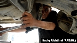 Many Afghan children work in auto repair shops.