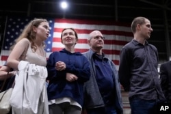 Alsu Kurmasheva (second from left) stands with two other American citizens -- Paul Whelan (second from right), and Evan Gershkovich (right) -- after they arrived in San Antonio, Texas, on August 2.