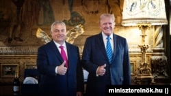 Hungarian Prime Minister Viktor Orban (left) and Donald Trump gesture for photographers earlier this year.