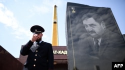 A Chechen police officer stands guard in front of the memorial for Akhmad Kadyrov, the father of current Chechen President Ramzan Kadyrov, in Grozny in July.