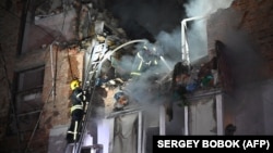 Rescuers extinguish a fire in an apartment building destroyed by a Russian missile attack in Kharkiv early on May 31 amid the Russian invasion in Ukraine.