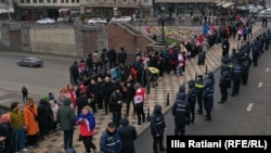 Georgian anti-government protesters form a "chain of unity" in Tbilisi on December 28.