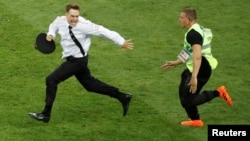 Pyotr Verzilov is chased by a steward during a World Cup protest on July 15.