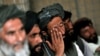 Afghans discuss security at a local council meeting in Helmand Province in June 2010.