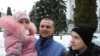 Ihor, 51, reporting for army training in Lviv with his 2-year-old daughter, Bozhenka, and his 14-year-old son, Nazar. 