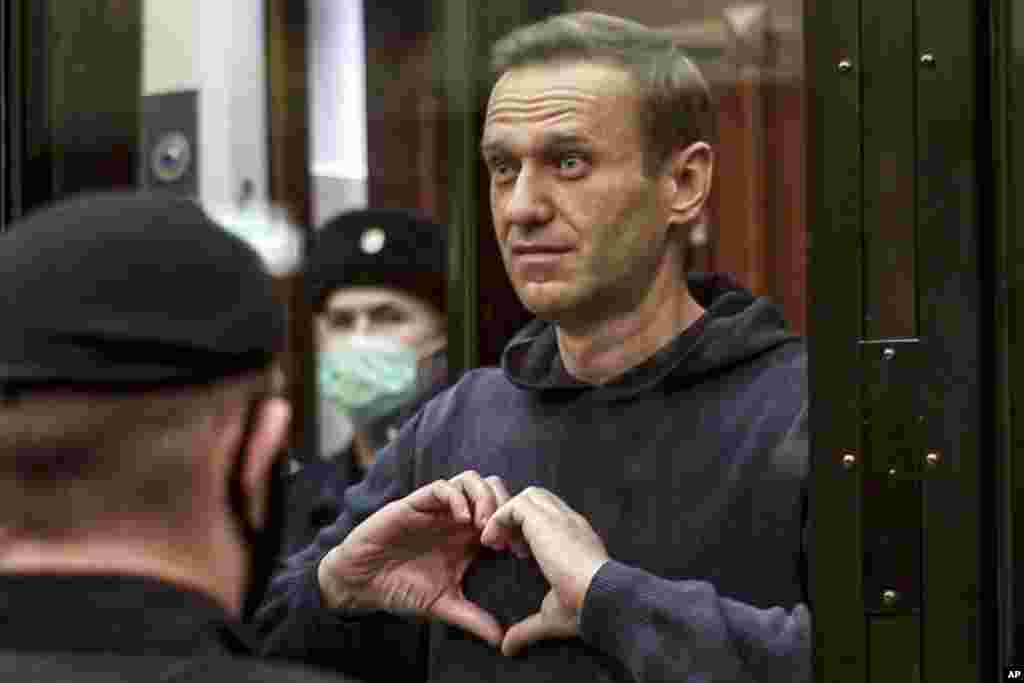 Navalny makes the heart symbol during a hearing at the city court in Moscow on February 2, 2021. He was sentenced to two years and eight months in prison.&nbsp;